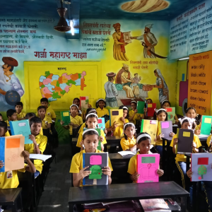 Children receiving recycled notebooks