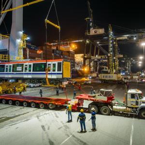 subway car getting loaded onto truck