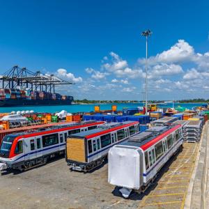 subway cars with ocean and boats in background 