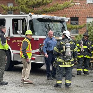 workers talking to firemen