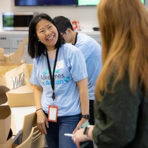 Volunteers smiling by open boxes.