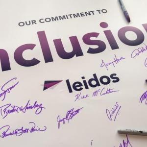 Signed poster that reads " Our Commitment to Inclusion, Leidos"
