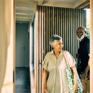Two people entering a building 