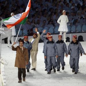 Shiva Keshavan holding the India flag with others in the olympic flag ceremony.