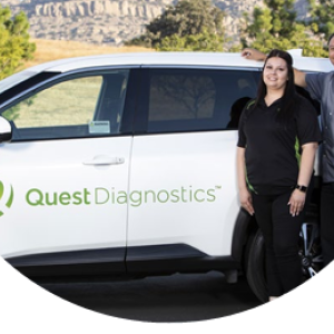 Two people standing by a car with "Quest Diagnostics" on the side.