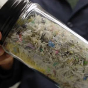 Someone holding a jar of food