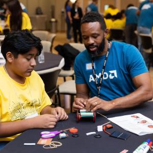 A student and an AMD volunteer working on a project
