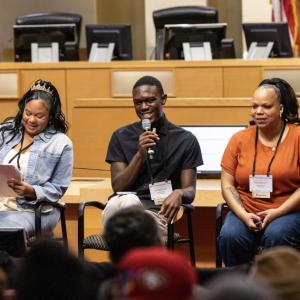 Three people presenting to a group