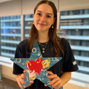 intern holding a SpongeBob painted star