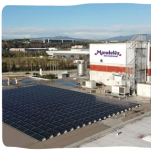 Aerial view of a block of solar panels beside a Mondelez factory.
