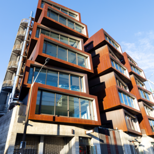 Six story angular building with weathered exterior