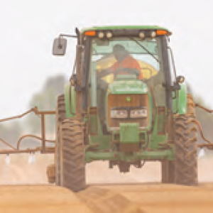 A tractor spraying a bare field