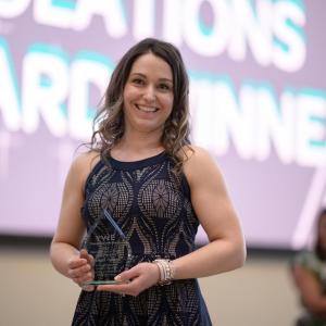 Isabelle Varney holding an award.