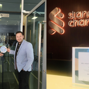 2 people next to the WELL Health-Safety Rating 