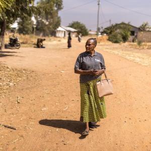 Janet walks from home to home to check on mothers and children.