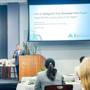 A person stood on stage speaking at an event