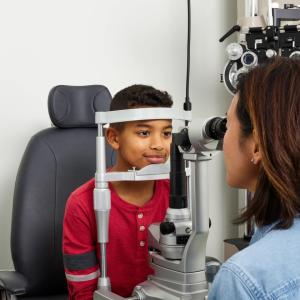 Eye doctor examining young boy 