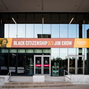 Exterior view of the museum. A banner across the doors "Black Citizenship in the era of Jim Crow"