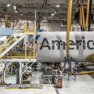 An American airplane being worked on in a hanger.
