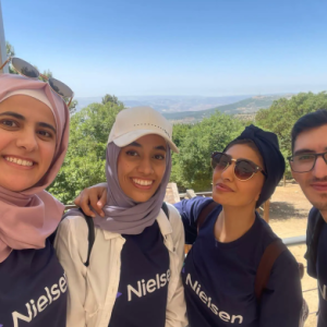 Four people take group selfie 