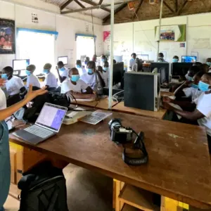 Kavya Krishna teaching a classroom of students each sitting with a computer.
