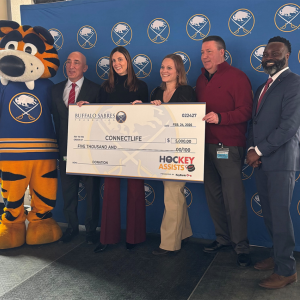 People standing with an oversized check