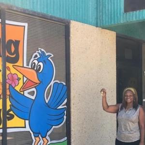 A person holding up a set of keys outside Bailey’s Child Development and Learning Center