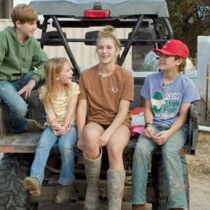 Four kids in the back of a four-wheeler