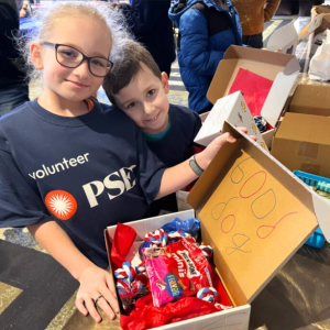 2 kids with donation boxes