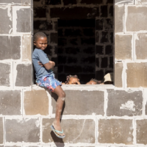 Kid sitting on window