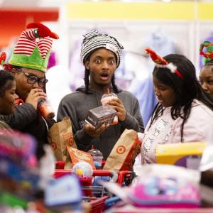 Kids gathered around a table of toys, one is very surprised.