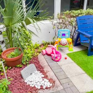 Kids toys and a blue chair in a grassy area