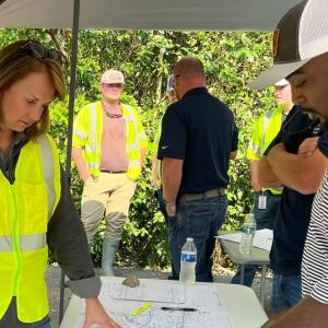 Kim Greene and another looking at information on a table outside.