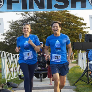 2 people run across the finish line