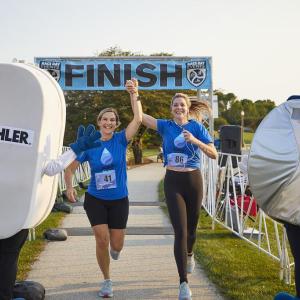 2 people celebrate crossing the finish line