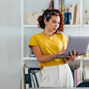 Person using laptop while standing 