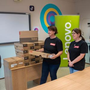 People in line, picking up laptops.