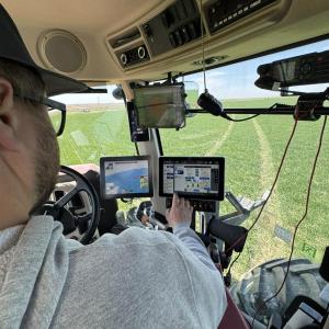 A person sitting inside a machine, looking at screens