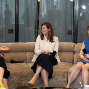 Mary Jacques and two others with microphones on a circular couch.