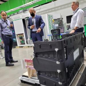 Three people inspecting a machine.