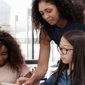adult and two children on a computer