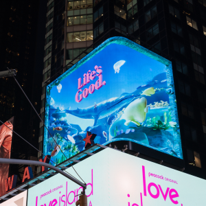 Lit billboard: "Life's Good when we protect wildlife"