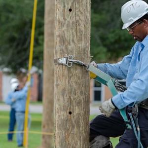 Lineworker on telephone pole