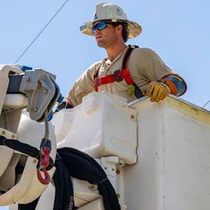 A line-worker in a bucket-lift near power lines