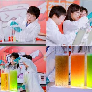 A collage of four images of people in protective lab gear doing an experiment with three tubes of liquids.