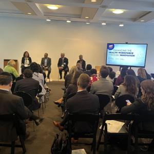 Four people sat in front of an audience 