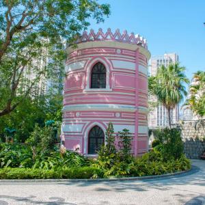 A round structure in a park setting, colorfully painted.