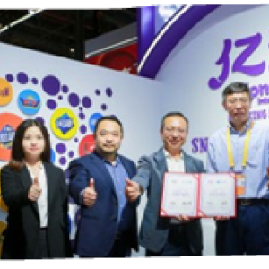A group of six people posed, giving thumbs-up. Two hold awards.