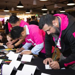 Volunteers writing on cards.