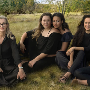 Women on sitting on the ground dressed in black